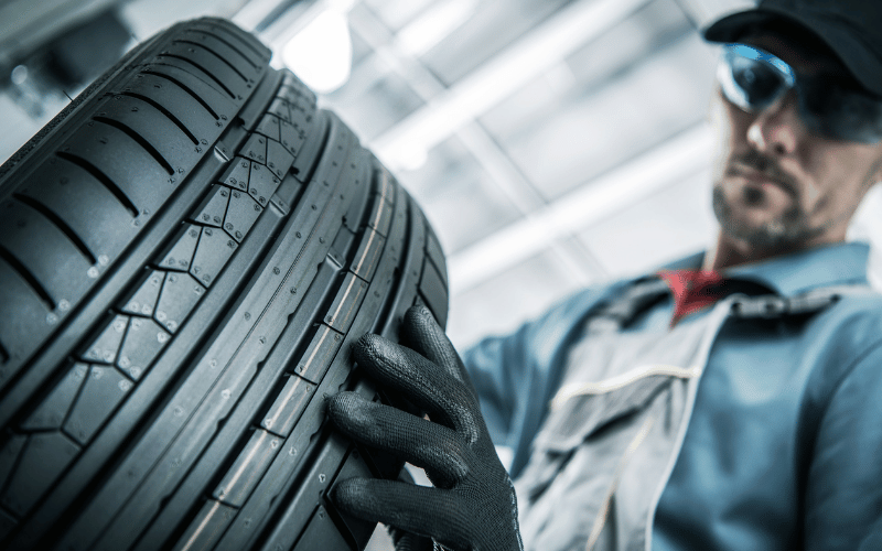 Car Tyres - man holding car tyre