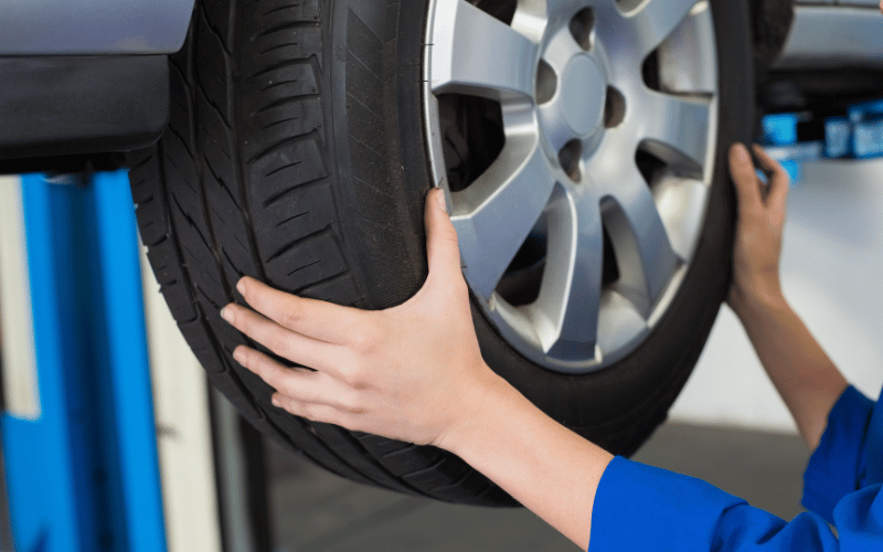 Car Tyres - man working on a car tyre