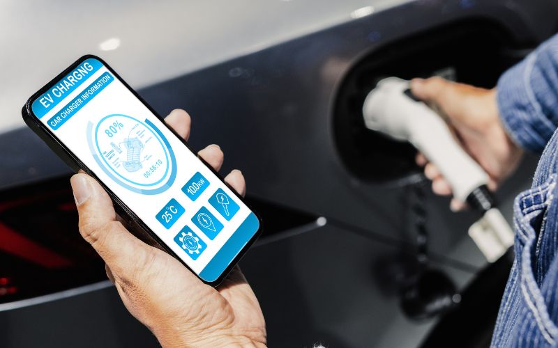 Electric Vehicle App - image of a man holding a phone with EV app